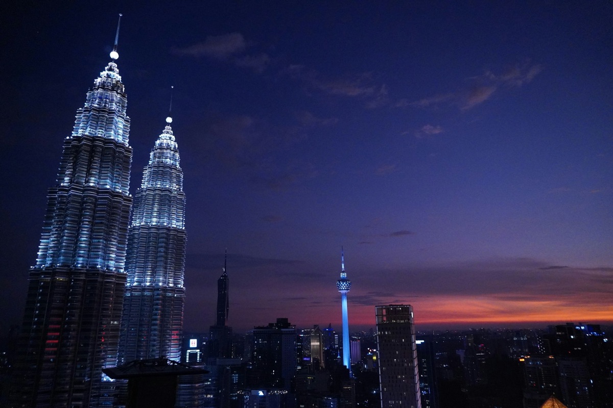 The Petronas Twin Towers lit up at dusk in Kuala Lumpur, Malaysia