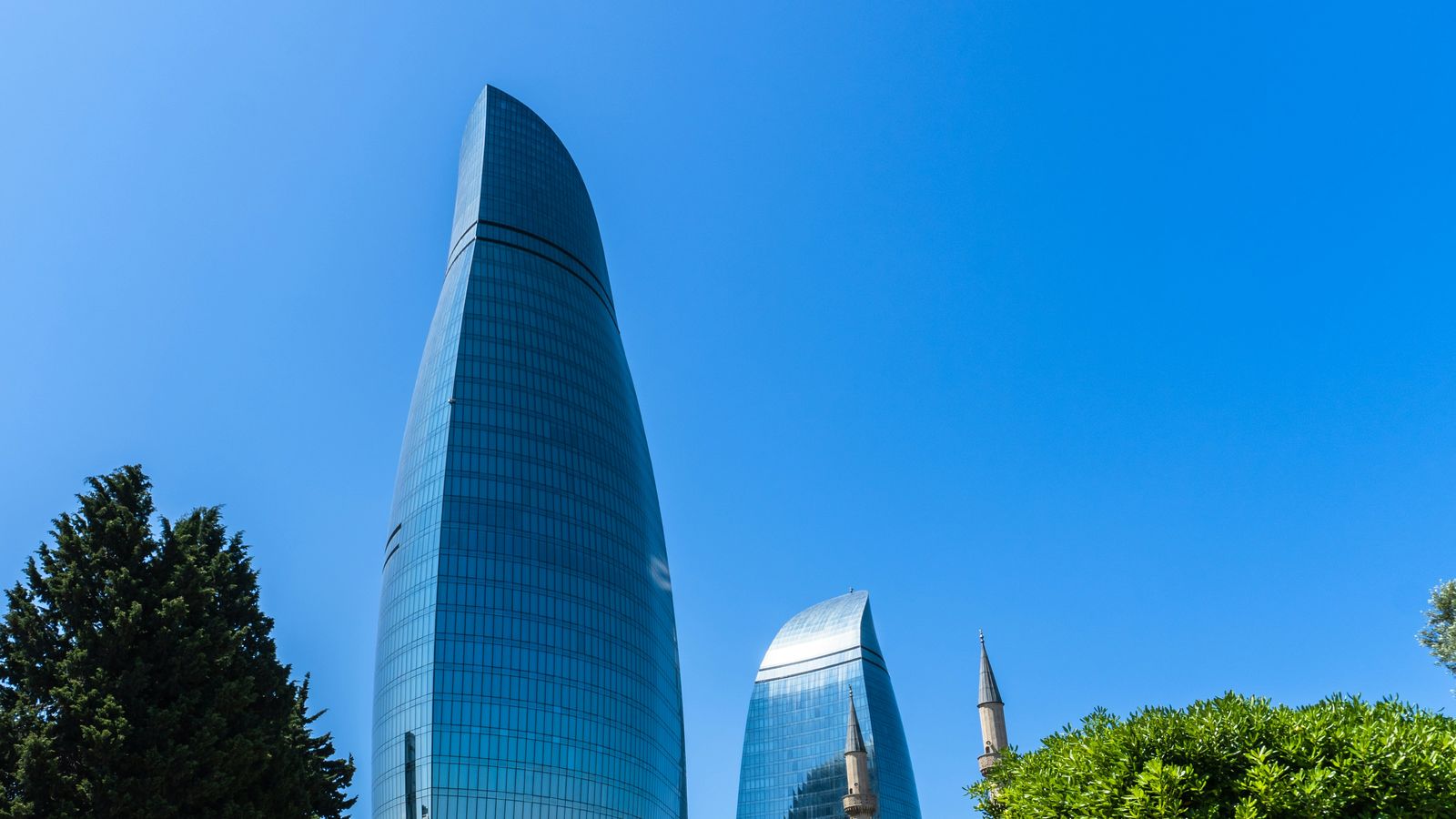 The Flame Towers under a clear blue sky in Baku, Azerbaijan