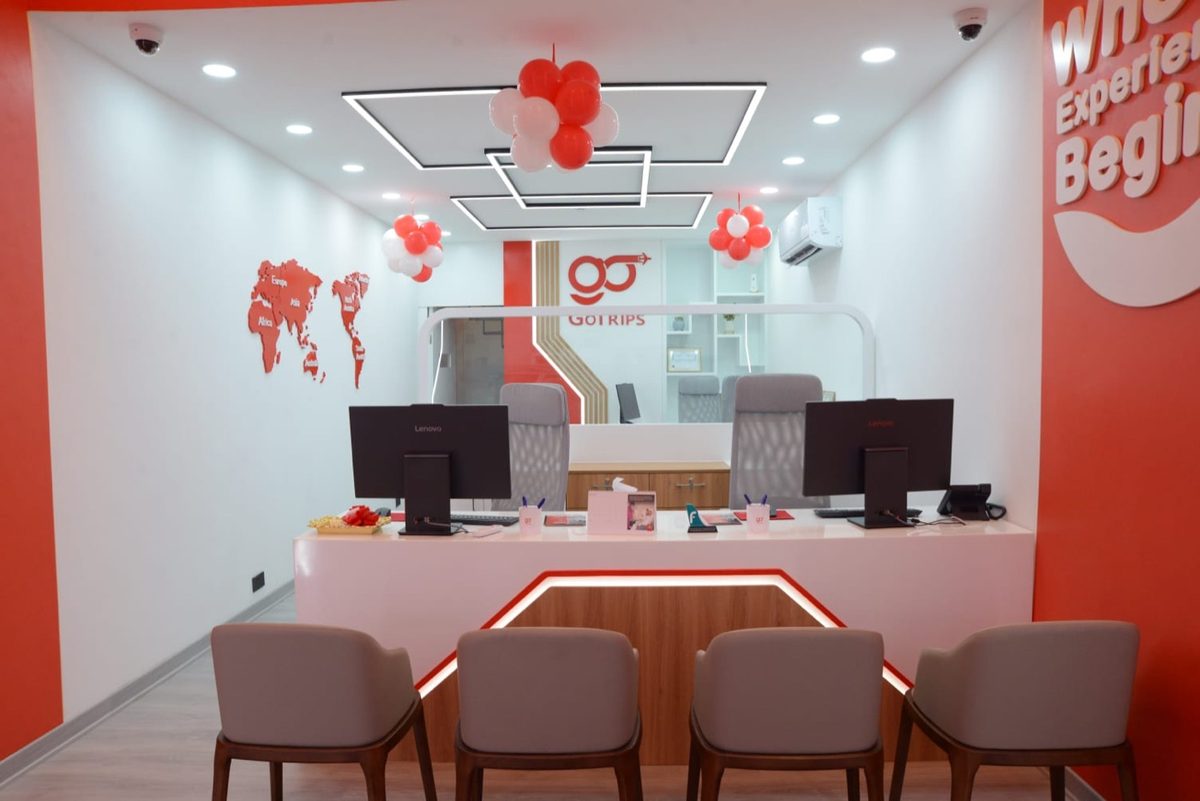 The GoTrips reception counter in Riffa, with the Where Experience Begins wall
